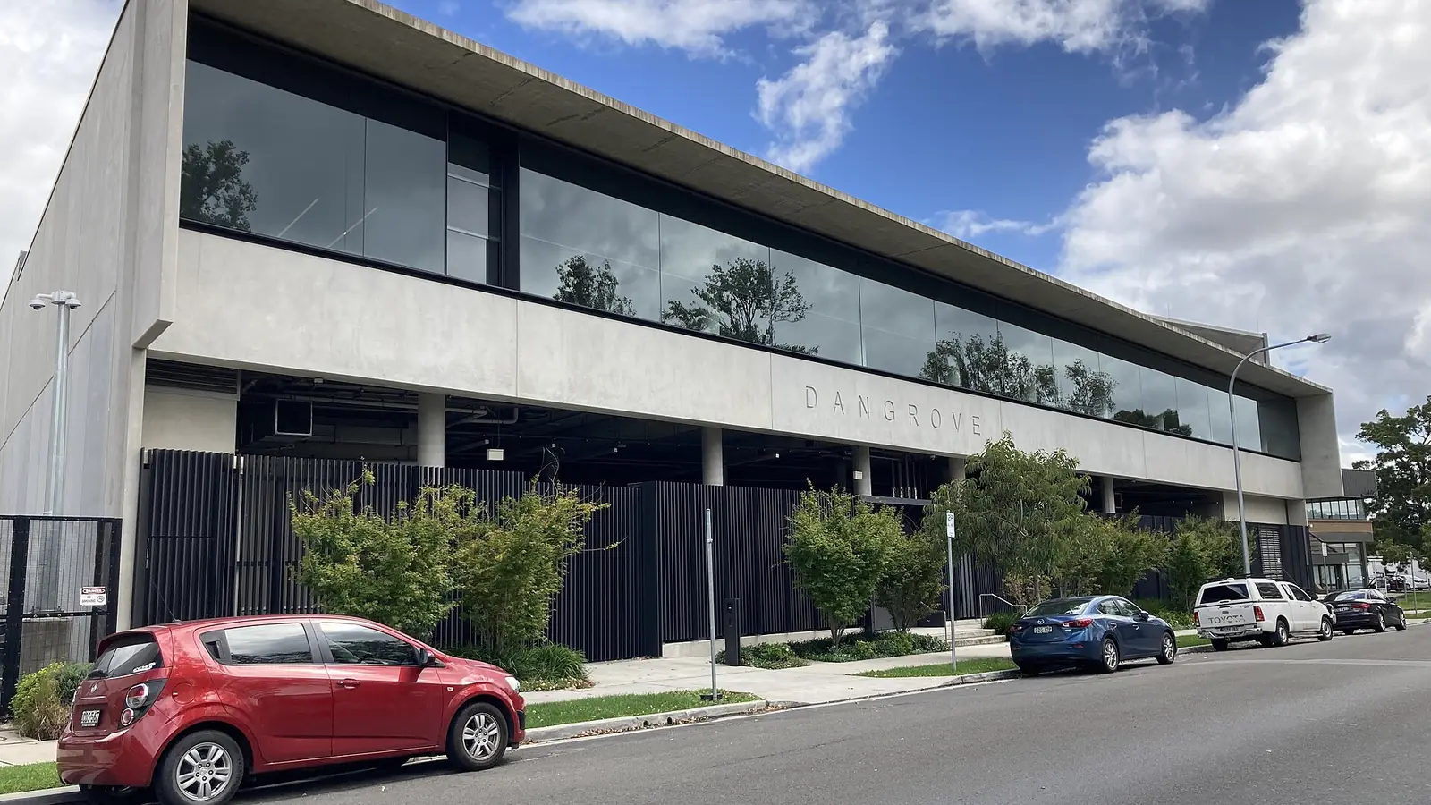 Modern two-storey storage and light-industrial building seen from the street